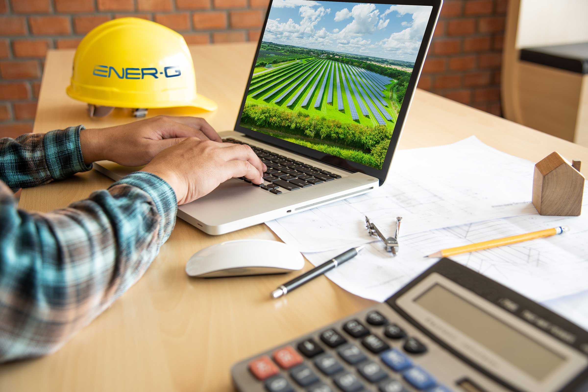 The Solar EPC Contractor UK Engineer works on the laptop