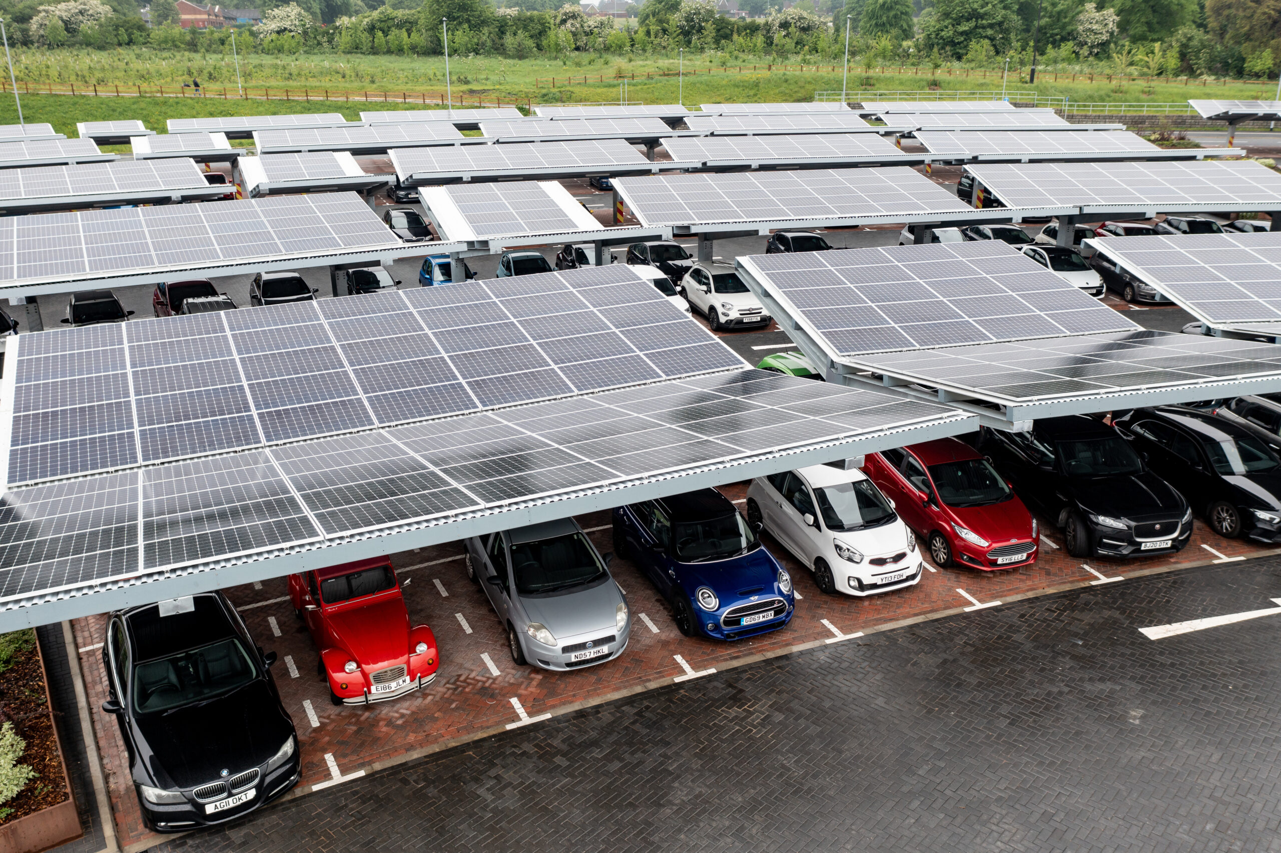 Aerial view of solar panels on a car port rooftop.